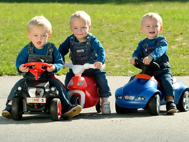 Toddlers on toy cars